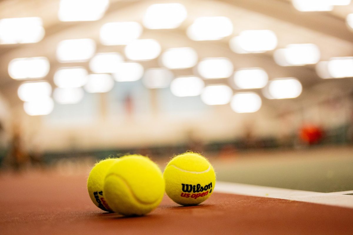 Tennis balls lie on the court in the Roberta Alison Baumgardner Tennis Facility.