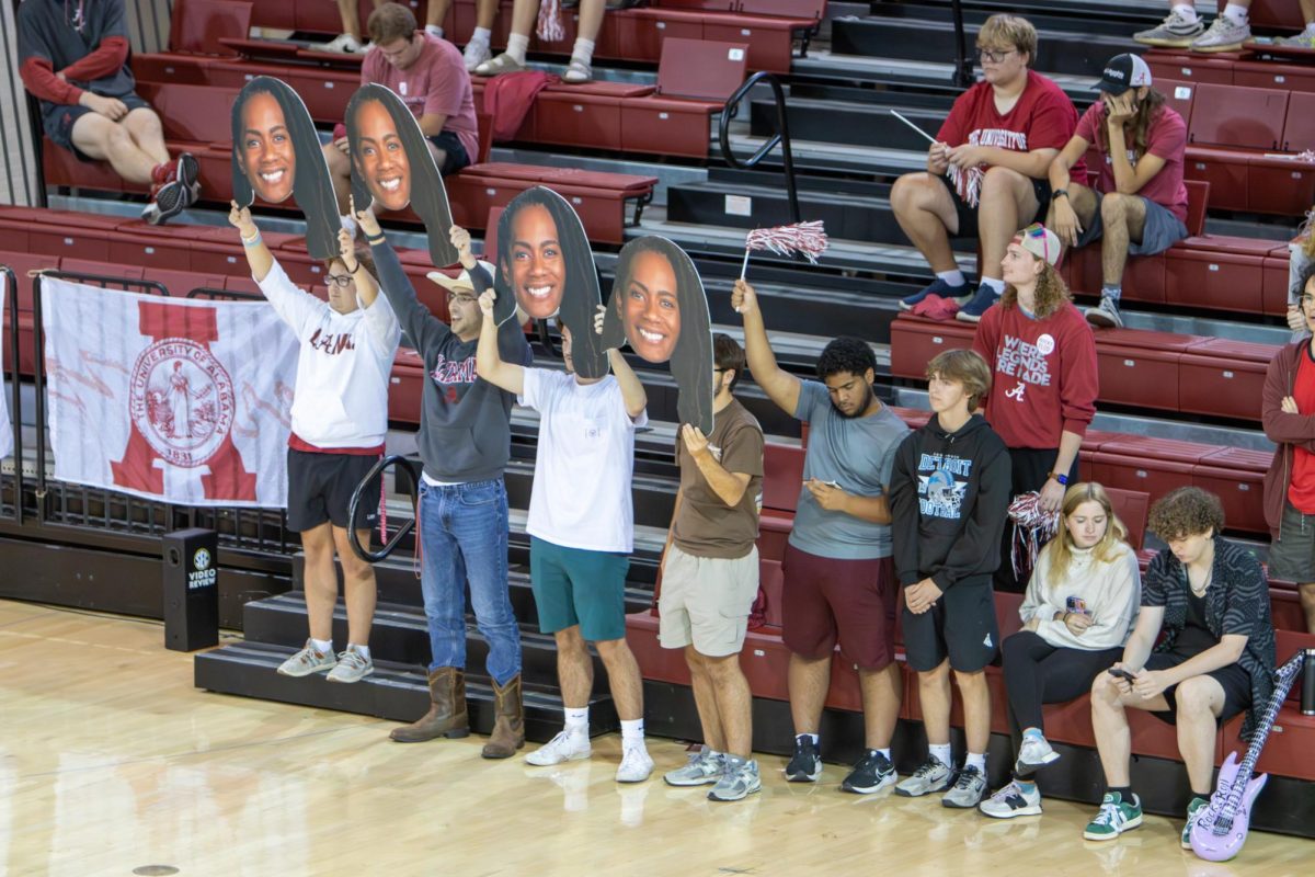 Fans cheer with fatheads of volleyball coach Rashinda Reed during the game versus Tennessee on Oct. 24, 2025.