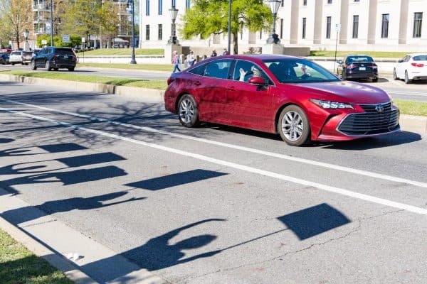 A person driving by waves at demonstrators at the No Kings Protest on March 28, 2026, in Government Plaza.