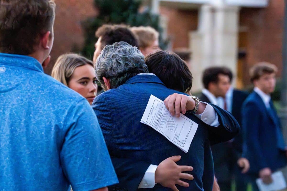 Attendees embrace outside the memorial service.