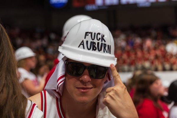 An Alabama student points at his hard hat.