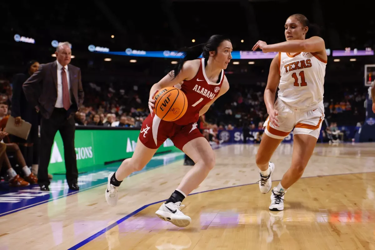 Alabama Guard Ace Austin (1) dribbles against Texas during the Third Round of the SEC Tournament at Bon Secours Wellness Arena in Greenville, South Carolina on Friday, Mar 6, 2026.