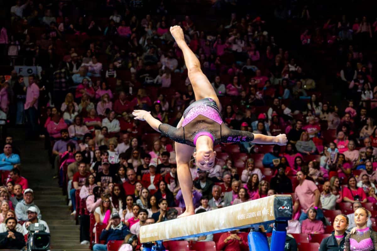 An Alabama gymnast performs a beam routine against Arkansas on Feb. 13, 2026, at Coleman Coliseum.