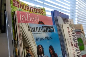 Editions of Alice Magazine, Nineteen Fifty-Six and The Crimson White sit in a stand in the Office of Student Media.