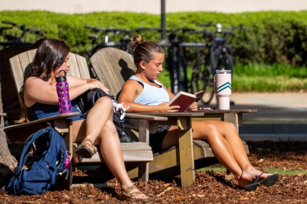 A student reads outside on the Quad on Apr 14, 2026.
