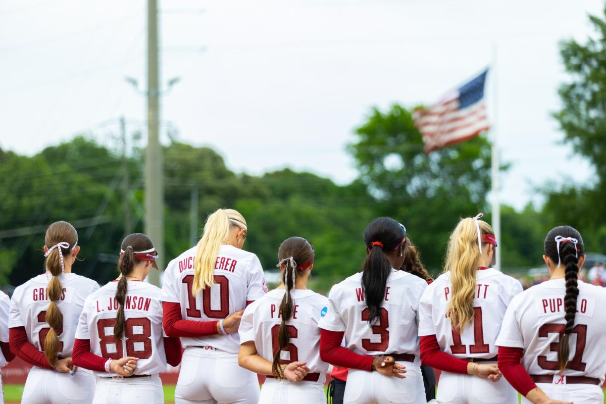 The 2025-2026 Alabama softball team stands for the National Anthem before the game against LSU on May 22, 2026, at Rhodes Stadium.