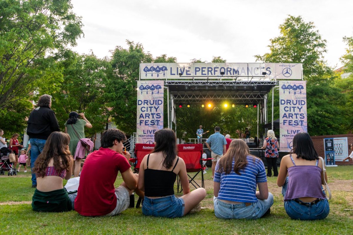 Guests watch a live performance at the Druid City Arts Festival on April 10, 2026.