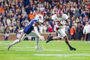 Alabama running back Jam Miller (#26) runs with the ball against Auburn on Nov. 29, 2025, in Auburn, Alabama.
